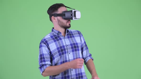 Young Bearded Hipster Man Using Virtual Reality Headset alt