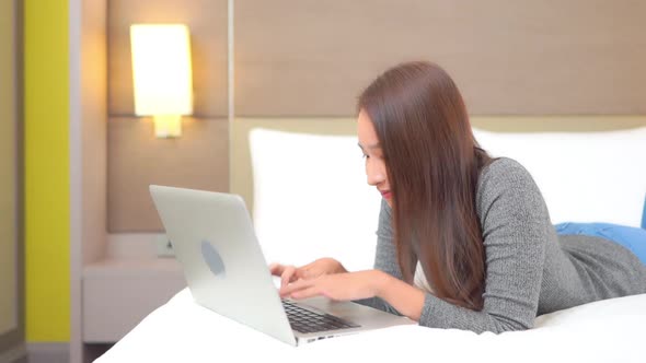Young asian woman use laptop alt