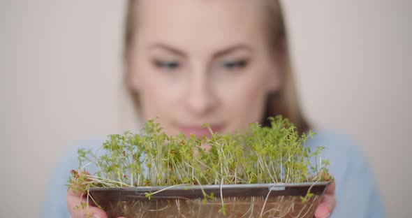 Happy Easter - Woman Holding Cuckooflower in Hands alt