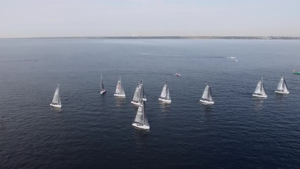 Sailing Yachts Lined Up in the Sea During a Sailing Regatta and Cast Shadows alt
