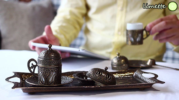 Drinking Coffee And Using Tablet