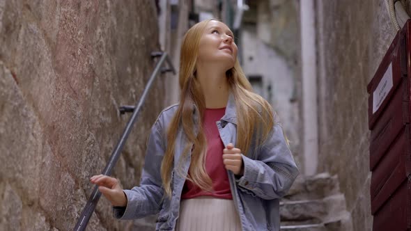 A Young Woman Visits the Old Town of Kotor in Montenegro alt