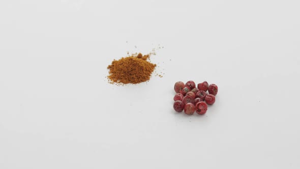 Red Pepper Powder Rotation. Macro Shot Against a White Background alt