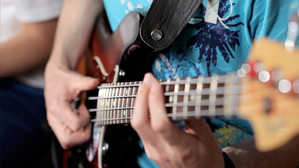 Men Playing At Bass In Music Studio alt