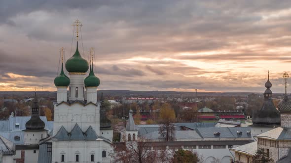 View of the Church of the Resurrection in Rostov Kremlin in front of a colorful sunset alt