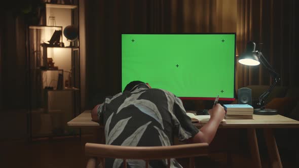 Bored Asian Boy Student Distance Learning With Mock Up Computer Green Screen From Home alt