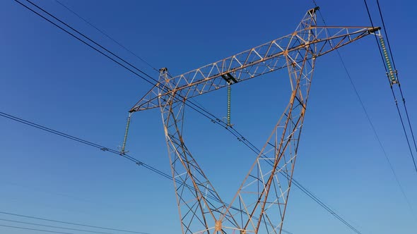 Transmission tower supporting an overhead high voltage power line - wires that transport electric alt