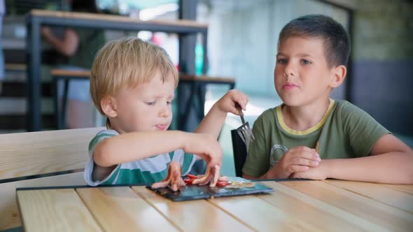 Kids Food, Cute Little Hungry Male Child with an Appetite Eating Healthy Breakfast Grilled Sausages alt
