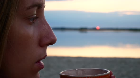 Girl Drinking Coffee On The Beach In The Morning