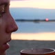 Girl Drinking Coffee On The Beach In The Morning - VideoHive Item for Sale