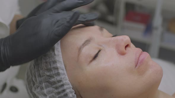 Closeup of a Young Woman in a Beauty Salon on a Cosmetic Procedure