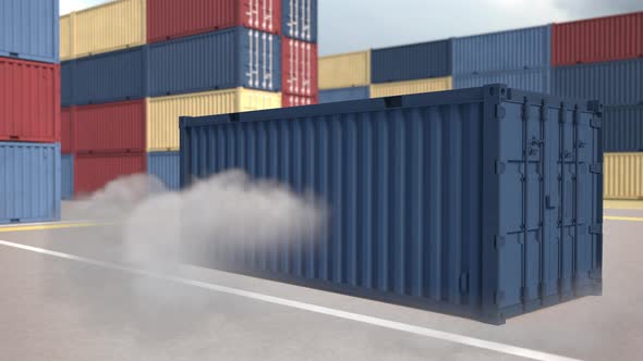 The blue container falls with clouds of dus