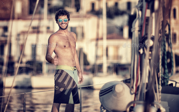 Happy man on the sailboat - Stock Photo - Images
