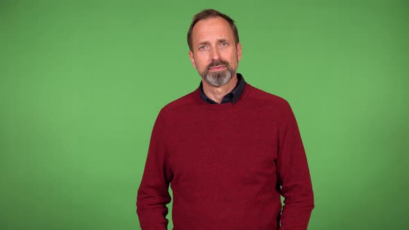 A Middleaged Handsome Caucasian Man Poses for the Camera  Green Screen Background