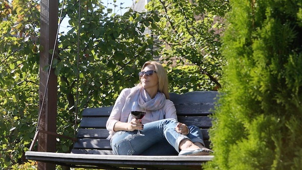 Woman Is Drinking Wine In The Garden