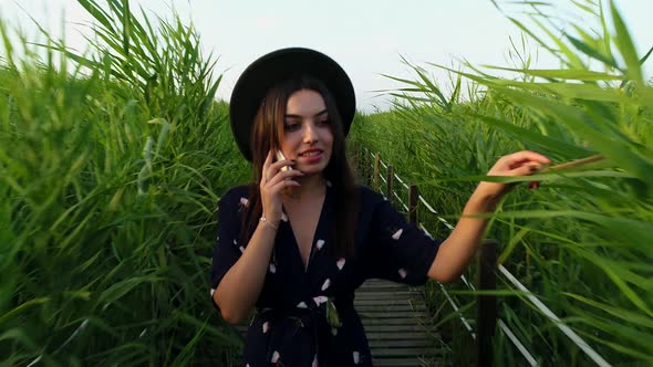 Happy Woman Talking Smartphone alt