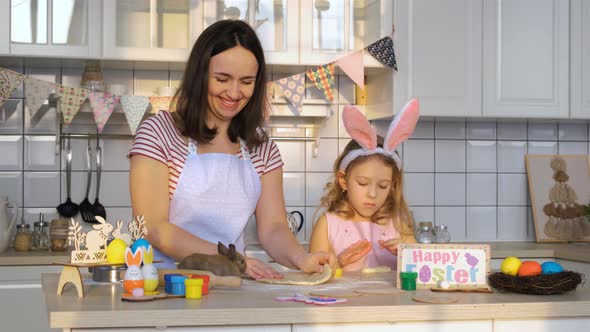 Family Rolling Dough with Easter Bunny in Kitchen alt