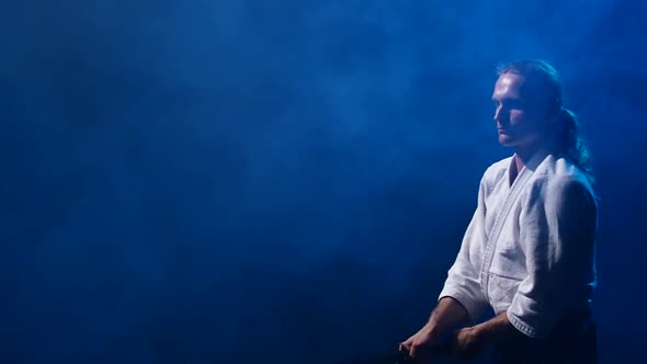Man Fighting at Aikido Training with Japanese Sword Katana in Martial Arts School. Healthy Lifestyle alt