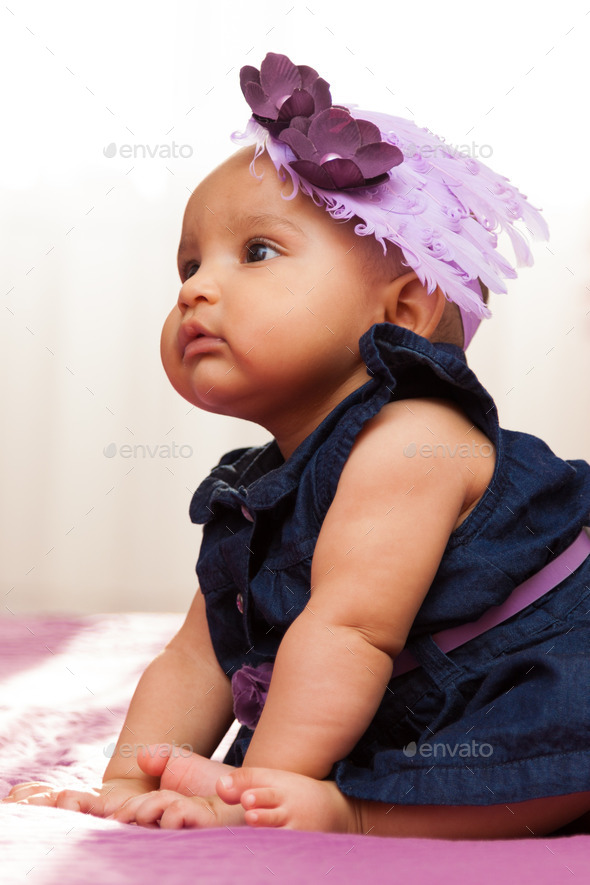 Adorable little african american baby girl looking - Black peopl - Stock Photo - Images