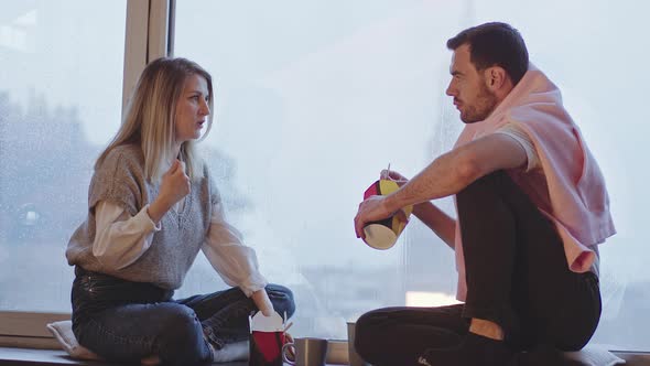 Man and Woman Eating Wok Noodles By the Window Overlooking the City alt