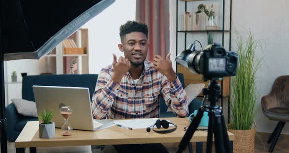 Man Sitting in front of Camera in Contemporary Home Office During Recording Videovlog alt