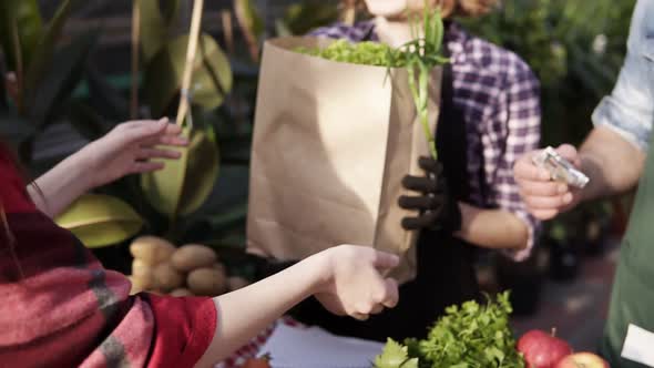 Unrecognizable People Selling Organic Food in a Local Harvest Market alt