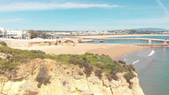 Batata Beach barred by Eroded cliffs and Solaria pier in Lagos, Algarve, Portugal alt