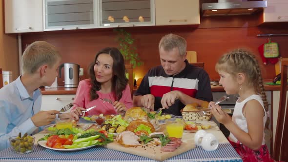 Family Dinner Serving Delicious Meal at Festive Celebration People Sitting at Table Enjoying alt