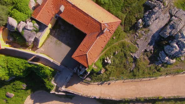 Aerial view over pilgrims house of Capela de Nossa Senhora da Peninha chapel, in Sintra, Portugal - alt