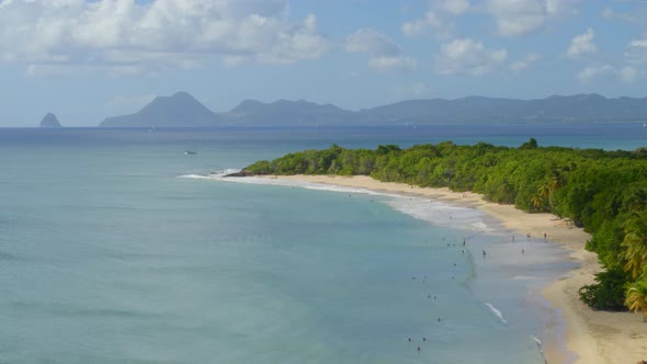 Aerial of tourist on beautiful sea coast at Grande-Anse, les Saintes alt