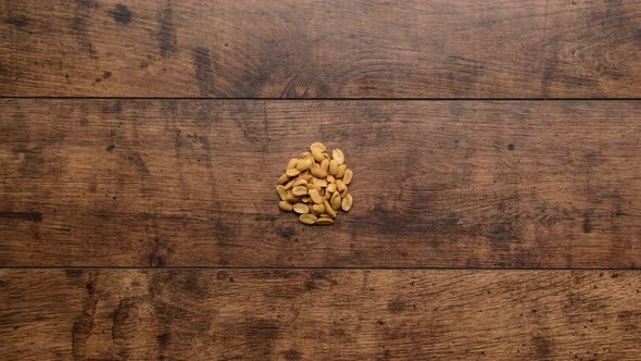 Diffeerent Kind of Nuts Increasing From One to Handful Wooden Background Stop Motion Animation alt