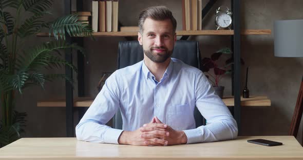 Smiling Beautiful Millennial Business Man Sitting at Table Looking at Camera Holding Web Camera Call alt