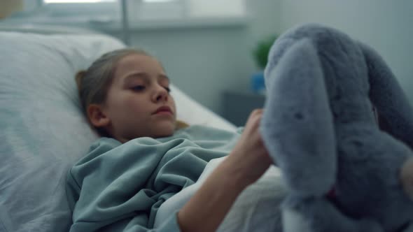 Upset Girl Lying Hospital Bed Portrait alt