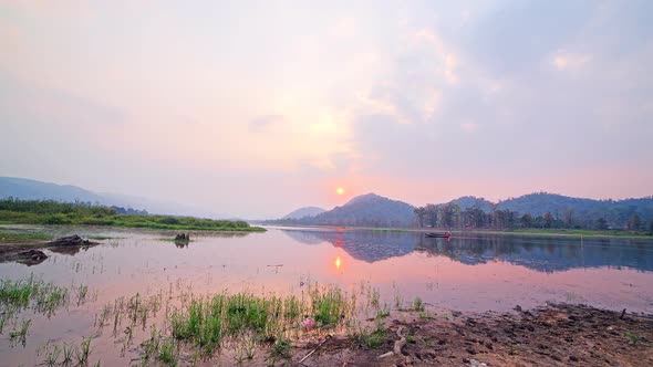 Timelapse of Sunset at Chandubi Lake, Guwahati City, with people rowing boats alt