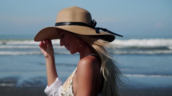 Young Attractive Girl Takes a Walk at Ocean Coastline alt