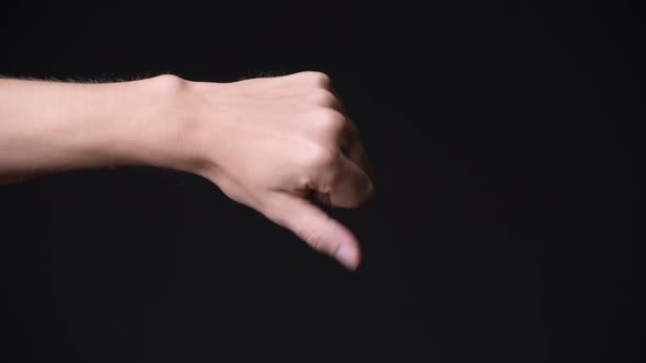 Hand of Young Man Giving Thumbs Down alt