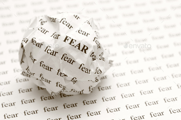Crumpled paper ball with words fear