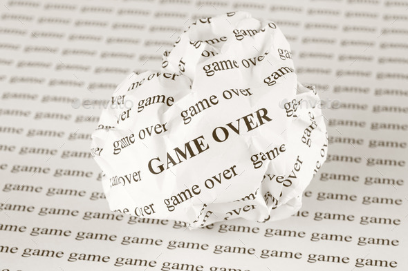 Crumpled paper ball with words Game Over