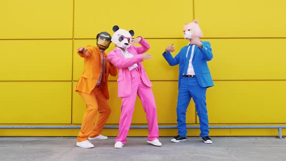 Dancing business people in vibrant suits and animal masks