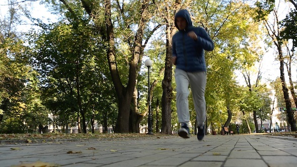 Man Is Running In The Autumn Park