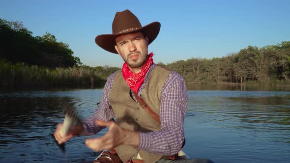 Cowboy in a Canoe Floats on the River alt