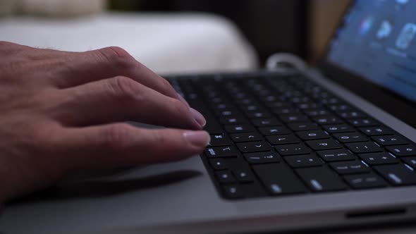 A man works on his laptop. Close-up of a slow-motion shot.
