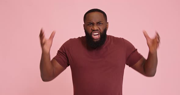 Young African American Man Mad Scream with Hands Up on Pink Background alt