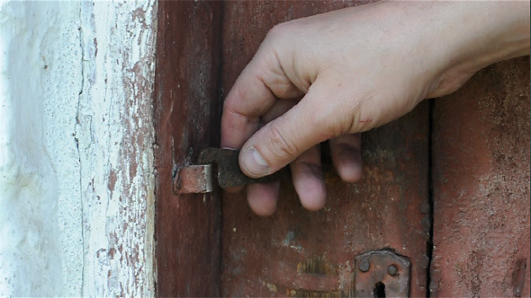 Hand Closes and Open Old Wooden Door with an Iron Latch
