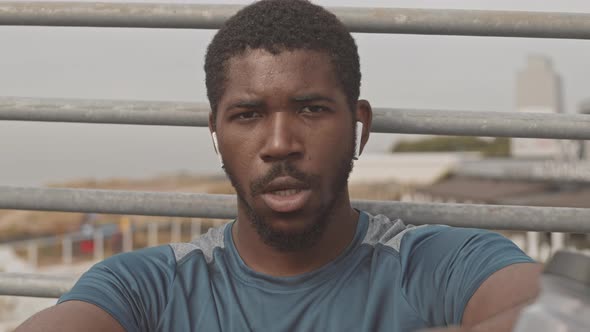 Portrait of Black Man Wiping Sweat after Training Outdoors alt