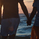 Loving Couple Holding Hands By Rough Wavy Sea - VideoHive Item for Sale