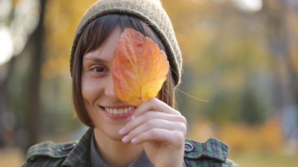 Girl Playing With Autumn Leaves