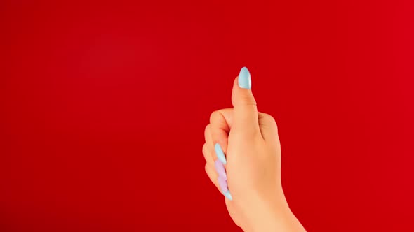 Woman's Hand with Beautiful Nails on Red Background alt