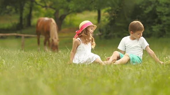 Little Boy Gives a Bouquet of Wild Flowers To a Girl. Slow Motion alt
