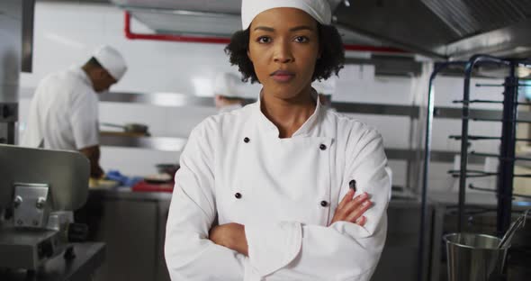 Portrait of african american female chef with arms crossed looking at camera alt